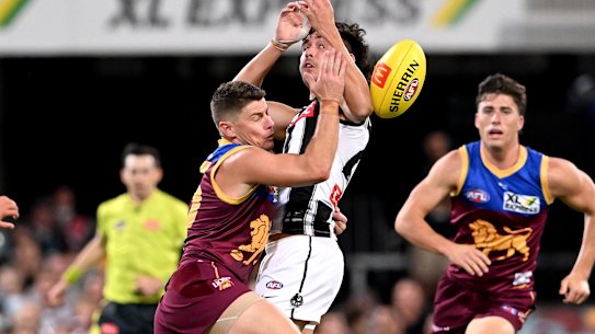 Dayne Zorko of the Lions and Reef McInnes of the Magpies.