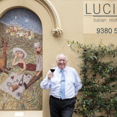 Lucio Galletto enjoying a glass of red beside regular Garry Shead's mosaic.