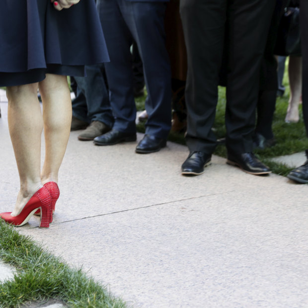 The contrast of Julie Bishop's red shoes against a sea of black footwear spoke to the Liberal Party's issues with female representation. 
