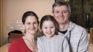 Elspeth and Mal Ennion and their five-year-old daughter Anya at their Randwick apartment.