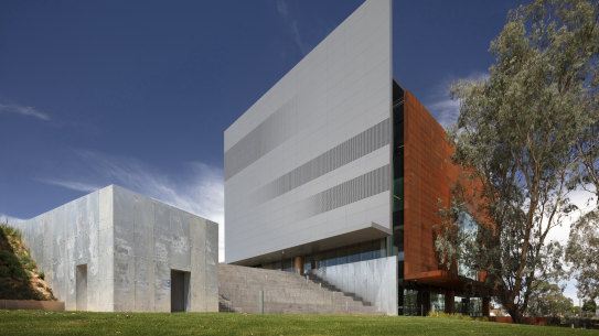 Four blade walls that don’t quite touch are each made with a different material.