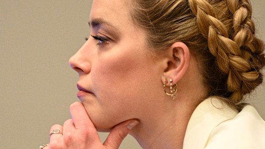 Amber Heard listens during the trial.