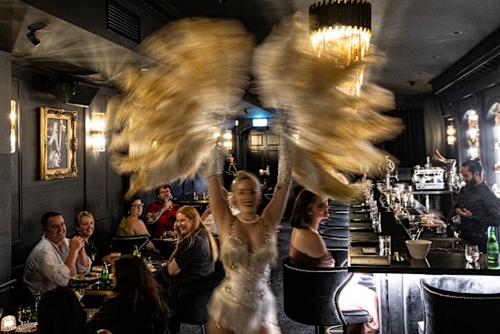 The room buzzes during the burlesque performance.