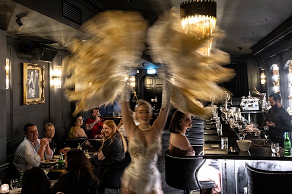 The room buzzes during the burlesque performance.