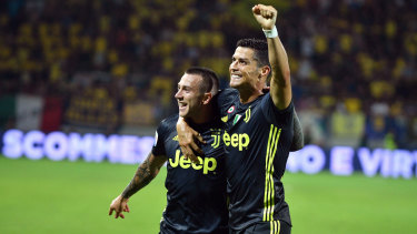 Cristiano Ronaldo celebrates with Juventus teammate Federico Bernardeschi.