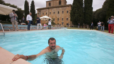 Interior Minister Matteo Salvini bathes in the swimming pool as he visits a villa seized in 2007 from a Cosa Nostra boss, in Suvignano, near Siena, central Italy. 