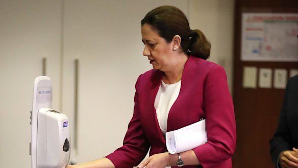 Queensland Premier Annastacia Palaszczuk sanitises her hands at Parliament House. 