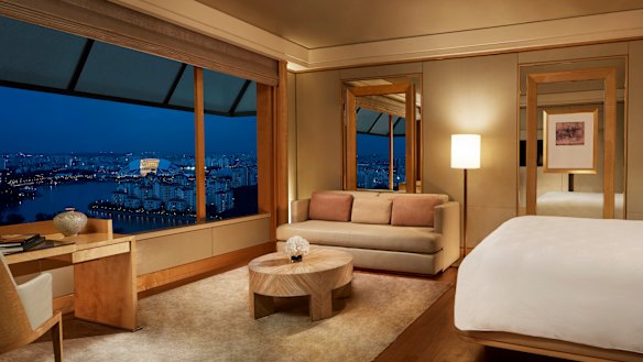 One of the luxurious subtly toned guest rooms, with spectacular city and water views, at the Ritz-Carlton, Millenia Singapore.