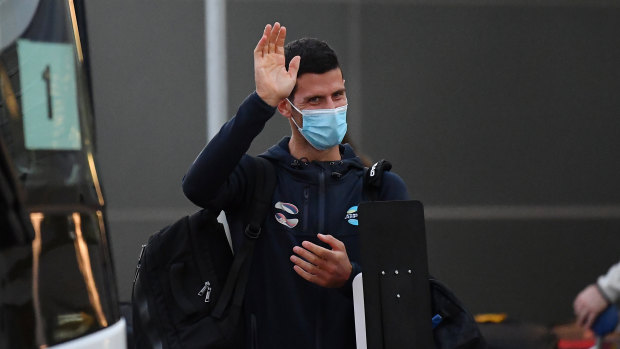 Novak Djokovic waves as he arrives at Adelaide Airport on Thursday. 