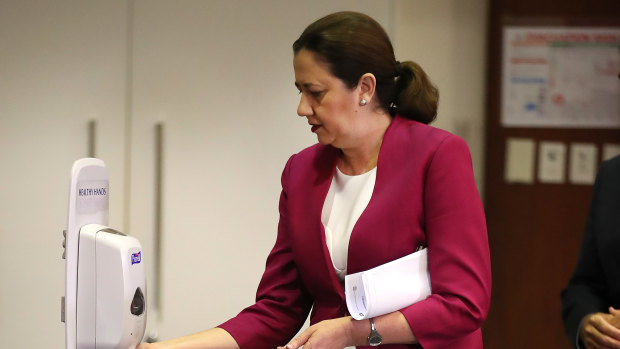 Queensland Premier Annastacia Palaszczuk sanitises her hands at Parliament House. 