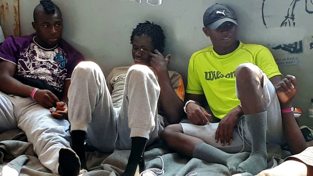 Migrants rest on board the Sea-Watch 3 vessel at sea in the Mediterranean before the ship's arrival in Lampedusa.