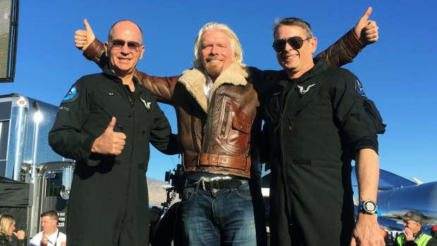 Richard Branson celebrated with pilots Rick “CJ” Sturckow, left, and Mark “Forger” Stucky, right, after the successful mission. 