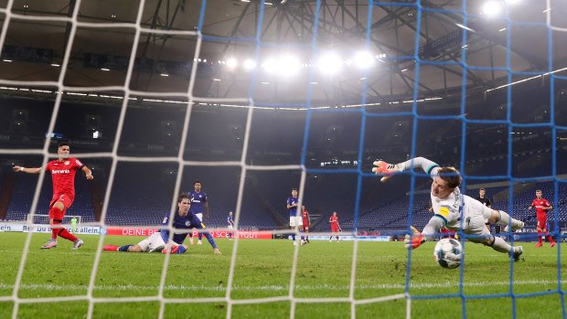 Leverkusen's Paulinho scores the opener for his side against Schalke.