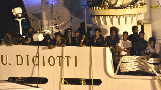 Migrants waiting to be disembarked from the Italian Coast Guard ship 'Diciotti' in the port of Catania, Italy, on Saturday.