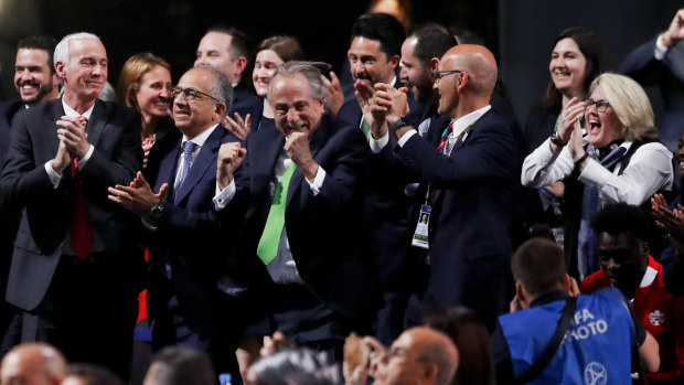 Delegates of Canada, Mexico and the United States celebrate after winning a joint bid to host the 2026 World Cup.