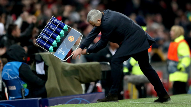 Going wild: Mourinho slams a rack of water bottles into the ground in an expression of “relief” after Manchester United snatched a last-gasp win to reach the Champions League last 16.