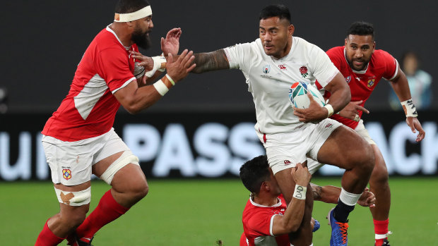 Manu Tuilagi of England makes a break during the Rugby World Cup match against Tonga.