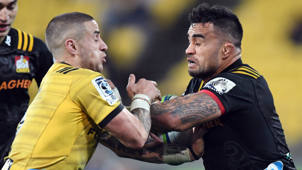 Face off: Liam Messam of the Chiefs grapples with TJ Perenara, who scored twice for the Hurricanes at Westpac Stadium.