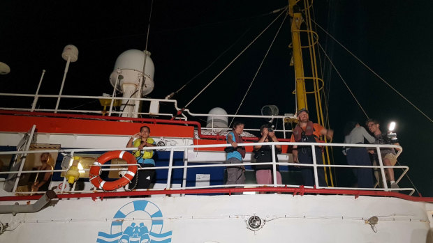 Captain Carola Rackete, left, watches as the Dutch-flagged Sea-Watch 3 ship docks at Lampedusa island's harbour early on Saturday.