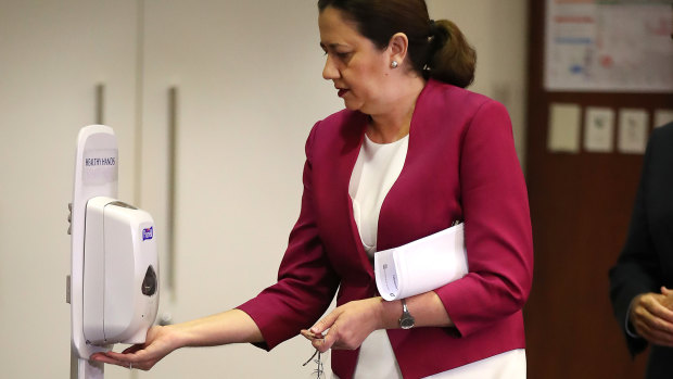 Queensland Premier Annastacia Palaszczuk sanitises her hands at Parliament House. 