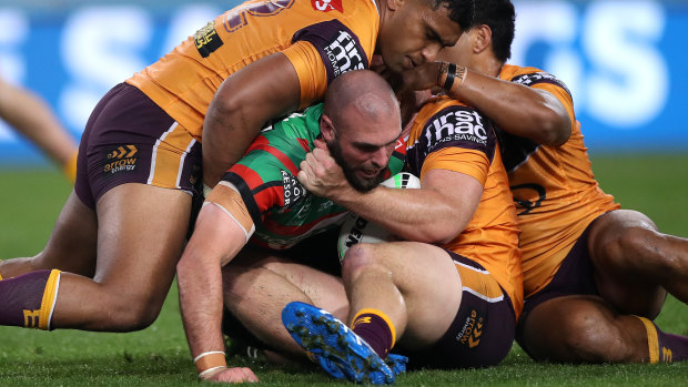 Mark Nicholls is tackled by the Broncos defence.