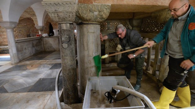 Workers clean up after high waters flooded the interior of St. Mark's Basilica in Venice.