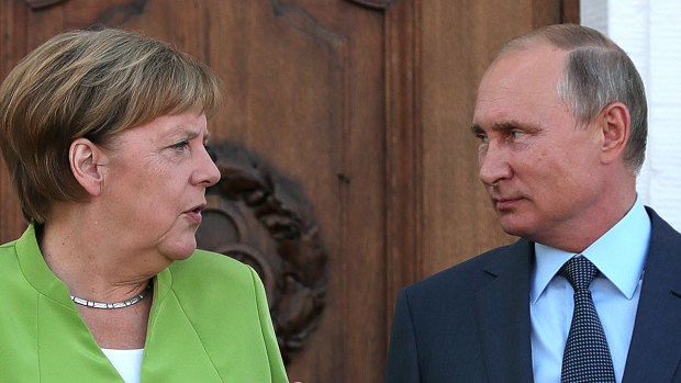 Angela Merkel, Germany's chancellor, left, speaks with Vladimir Putin, Russia's president, during a bilateral meeting at Meseberg castle in Meseburg, Germany.