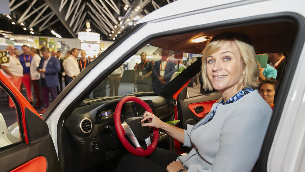Zali Steggall putting the badge on an Australian-assembled electric vehicle at the Smart Energy Conference.