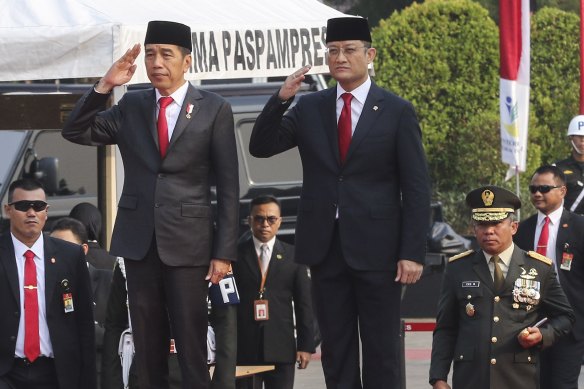 Indonesian Presiden Joko Widodo (left) and Indonesian Minister of Social Affairs Juliari Batubara (right) pay respect during attend the National Visitation at the Main National Heroes Cemetery in Kalibata, Jakarta, Indonesia last year. 