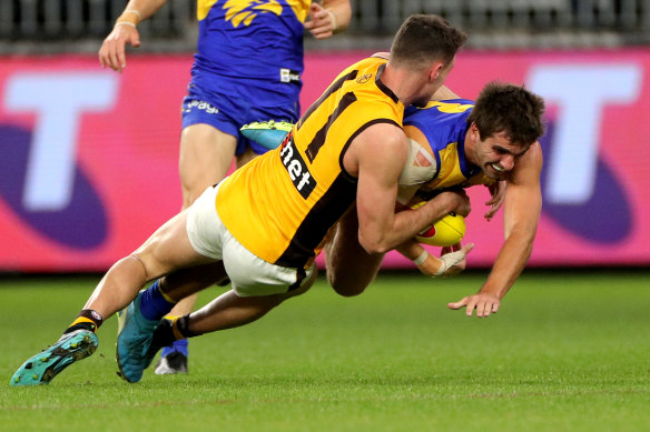 Ambushed: Hawthorn's Conor Nash takes down West Coast's Andrew Gaff on Saturday night in Perth.