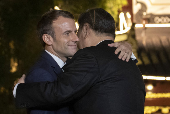 French President Emmanuel Macron and Chinese President Xi Jinping hug in 2019.