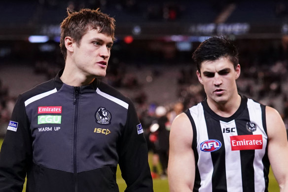 Magpies coach Nathan Buckley has declared Darcy Moore (left) a certain starter against the Cats.