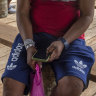 Marubo people use their phones, bought in the closest city, when the Starlink antenna is turned on in their village, in Manakieaway, Brazil.