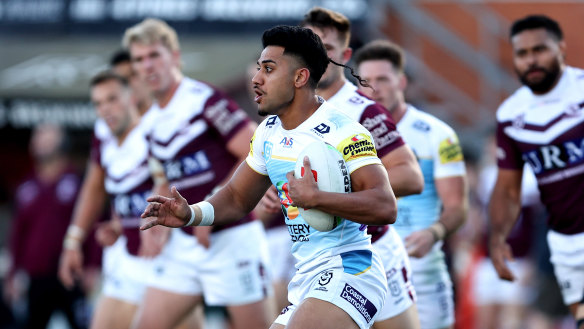 Alofiana Khan-Pereira of the Titans runs the ball against Manly.