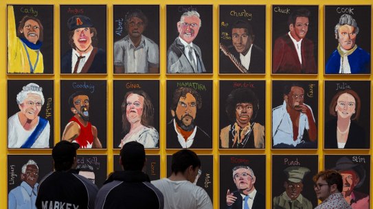 Gallery visitors view the artwork by Vincent Namatjira at the National Gallery on Friday.