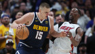 Nikola Jokic of the Denver Nuggets drives to the basket against Bam Adebayo of the Miami Heat.