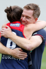 Pearce and Demons coach Mick Stinear embrace after winning through to this season’s AFLW grand final.