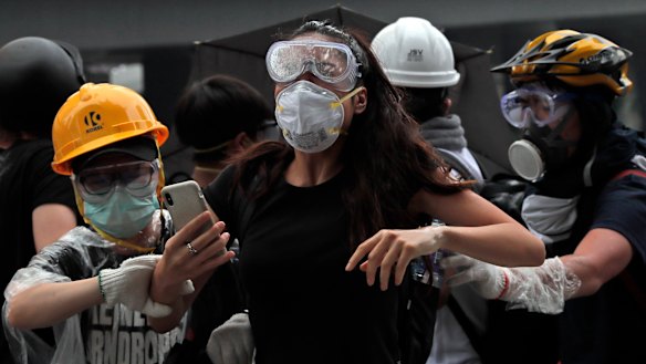 Protesters flee the tear gas.