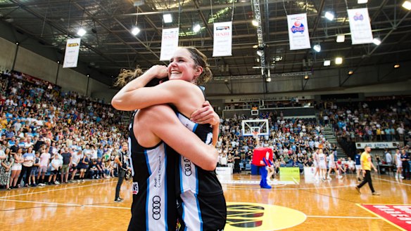 Canberra Capitals celebrate after winning the grand final.