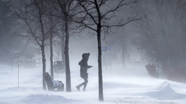 A pedestrian makes their way through frigid temperatures around Lake Bde Maka Ska in Minneapolis.  
