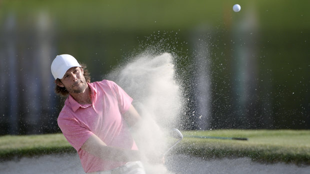 Aaron Baddeley hits out of a bunker onto the 17th green during the third round of the Arnold Palmer Invitational  tournament. 