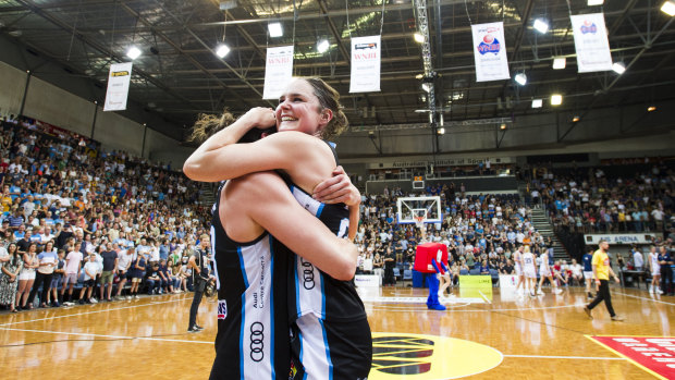 Canberra Capitals celebrate after winning the grand final.