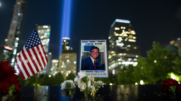 A picture of Robert Hughes who lost his life in the September 11 attacks is seen at ground zero while the Tribute in Light rises in the background, in Lower Manhattan on Wednesday.