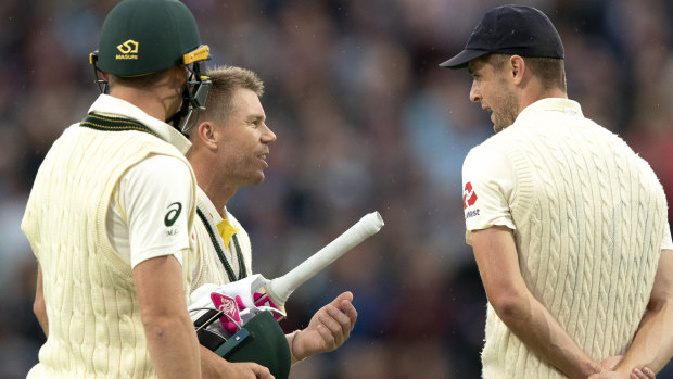 David Warner and Chris Woakes exchange words as the players came off for a delay.