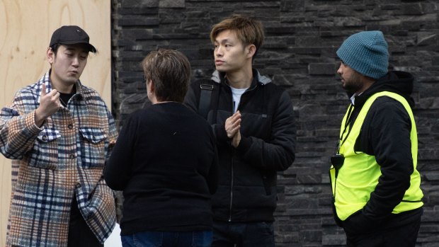 Residents including Top, second from right, outside Mascot Towers on Monday