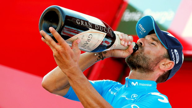 Well earned drink: Alejandro Valverde of the Movistar Team celebrates on the podium after the second stage.