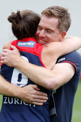 Pearce and Demons coach Mick Stinear embrace after winning through to this season’s AFLW grand final.