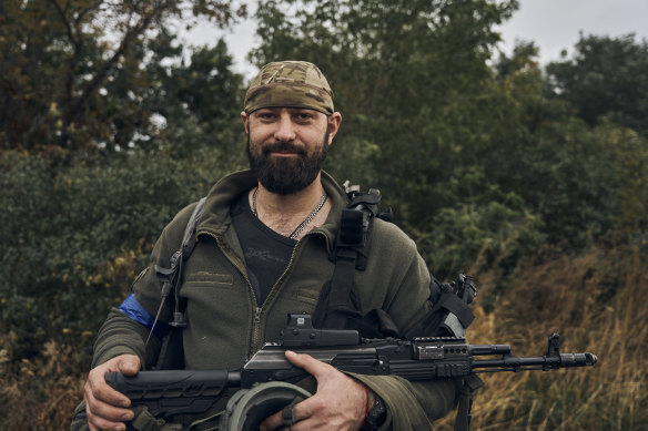 A Ukrainian soldier smiles in the freed territory in the Kharkiv region, Ukraine.