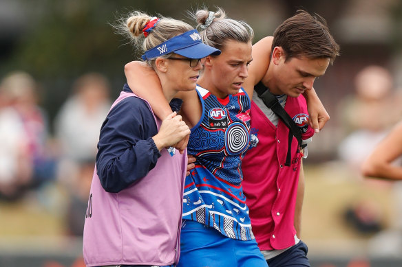 Deanna Berry leaves the field after her injury.