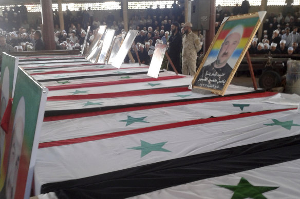 Mourners attend a funeral of people killed by Islamic State fighter suicide bombings in Sweida, Syria in July 2018.